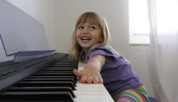 happy girl playing piano