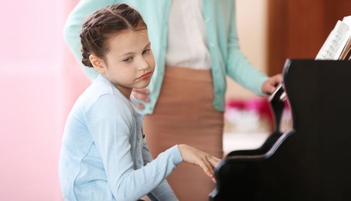 sad girl playing piano