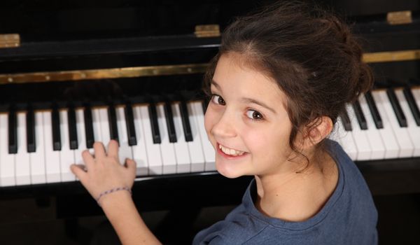 young girl playing piano — piano studio